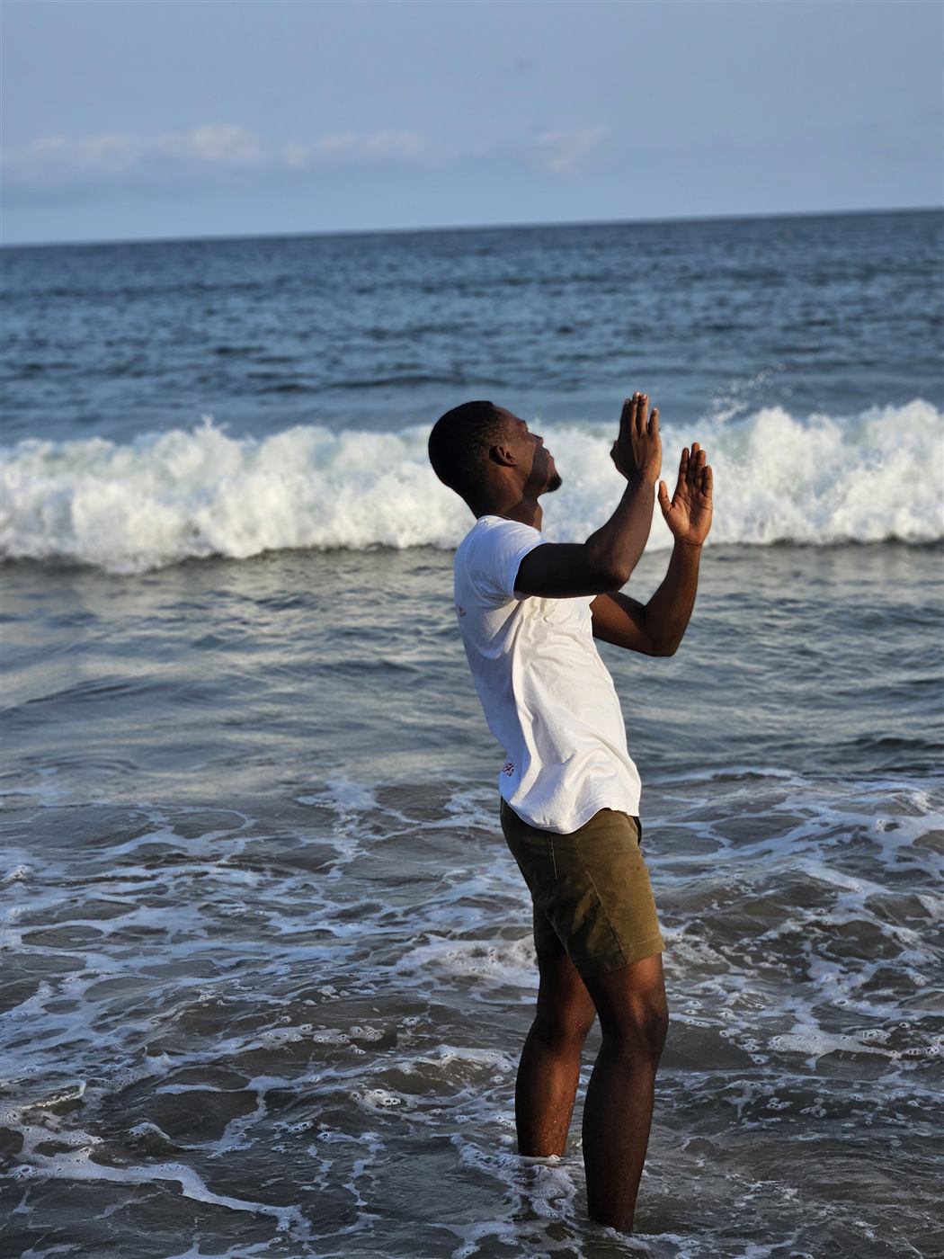 Tolulope Ajidahun standing in the Atlantic surf on a Lagos beach