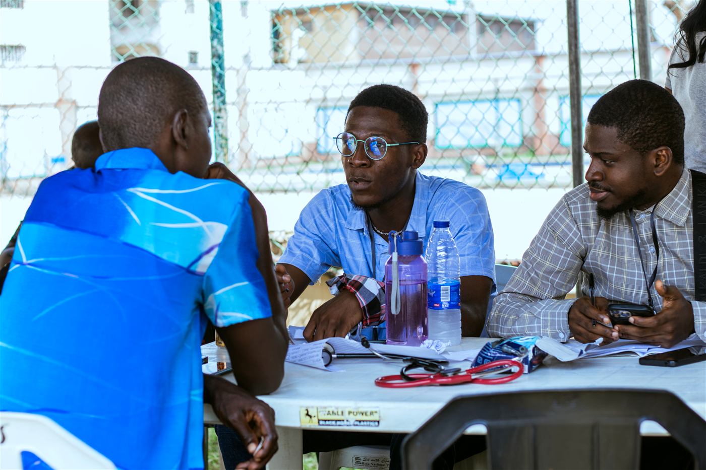 Dr. Tolulope Ajidahun consulting with a patient at a free community health outreach clinic in Lagos, Nigeria